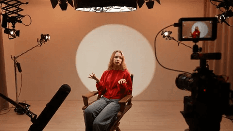 Person filming a pitch video on set